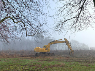 Large Earth Moving Equipment in Field on a Foggy Morning