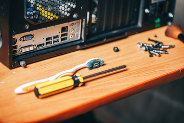 Dsassembling a computer with tools, screwdriver and brush for cleaning computer