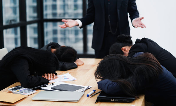 Lazy and tried Business people sleeping during meeting, disappointed Boss looking at them with unhappy feeling.  
