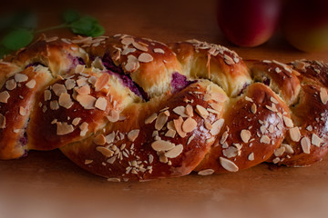 Easter sweet bread with almonds on wooden table