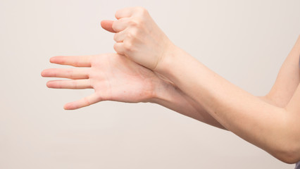 Parkinson's disease symptoms. Close up of tremor (shaking) hands of Middle-aged women patient with...