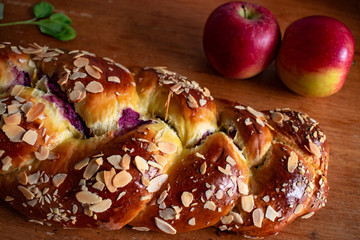 sweet bread with almonds on wooden table