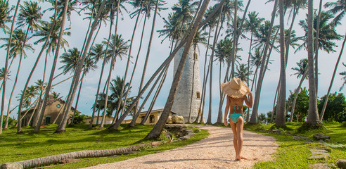 Child in Sri Lanka on an island with a lighthouse. Selective focus.