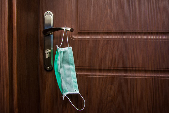 Protective Mask Hangs On The Door Handle, Put The Mask On Before Leaving The House, Protection Against The Virus