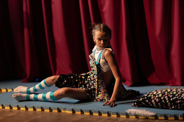 Girl show the performance on stage in the theater.