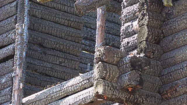burnt wooden log house, charred wood