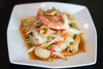 Thai papaya salad with fresh shrimp and crispy pork skin, a popular food for Thai people