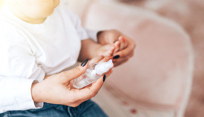 Mom and baby rub their hands with a sanitizer, how to wipe their hands, how to sit in quarantine, health care