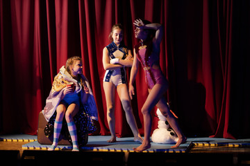 Girls show the performance on stage in the theater.