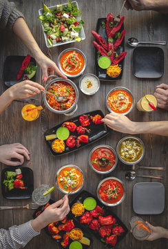 people eating in an Indian restaurant, view from above over the table