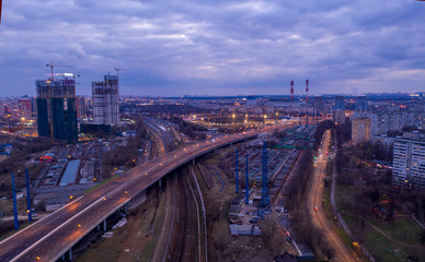 Fototapeta na wymiar the lights of the big city and the motorway at night shot from the drone