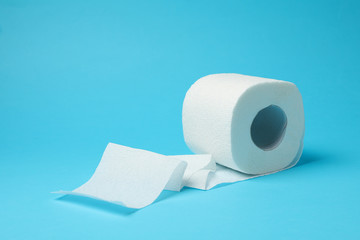 Toilet paper on blue background, space for text