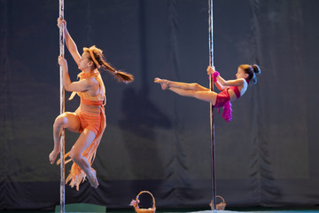 Girls gymnasts show the dance and performance on stage in the theater