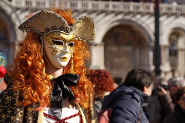 Fototapeta premium VENICE / ITALY - February 6 2016: Carnival performers participate this event in Piazza San Marco in Venice, Italy. The tradition began in 1162 to celebrate the defeated Ulrico, Patriarch of Aquileia