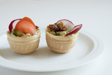 Two ready-made tartlets in a white plate.