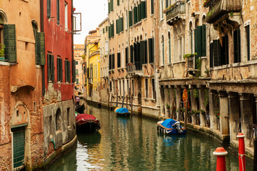Fototapeta na wymiar City scenery with canal and gondulas in Venice, Italy