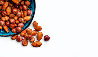 Nuts on a white background. Photo Nuts on a plate. Healthy eating
