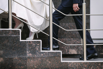 A couple of newlyweds going up the stairs