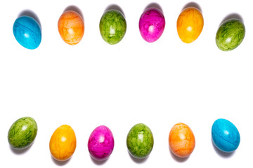 Two borders of easter eggs in different colors on white background