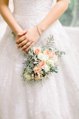 Obraz na płótnie Canvas Bride's flower, white flowers and silk ribbon. Couple shoot on wedding day.