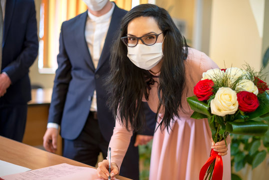 Couple In Love Just Married In Covid Pandemic. Signing Wedding Certificate