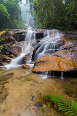 Fototapeta na wymiar Scenic View Of Waterfall In Forest Against Sky