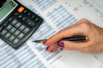 The report summarizes the results of business operations, pen, calculator on desk of investor.