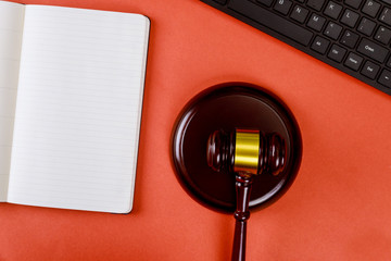 Workplace with notepad and keyboard judges wooden gavel