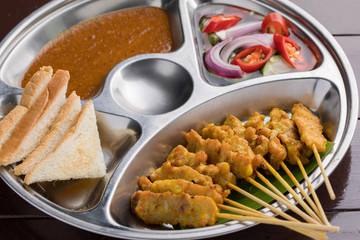 Pork Satay with Peanut Sauce and pickles which cucumber slices and onions in vinegar.