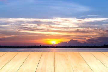 Fototapeta na wymiar Wooden plank on lake during sunset background.