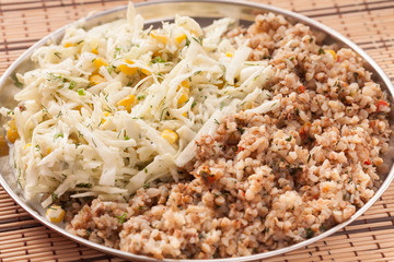 Plate of buckwheat and fresh cabbage salad 