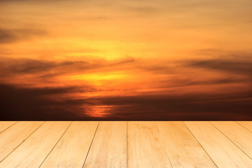 Fototapeta na wymiar Empty wooden plank table with sunset background.