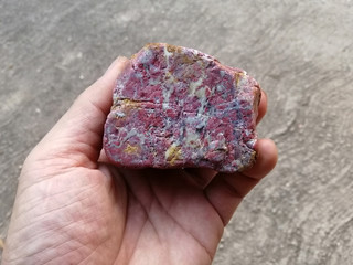 Red Jasper Stone in the hand. red stone, Jasper stone is an aggregate mineral commonly used in New...