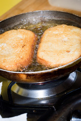 Frying bread to make a typical Spanish food, torrijas.