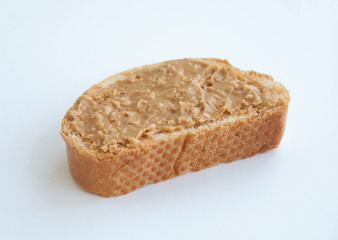 Peanut butter on toast slice, isolated on white background