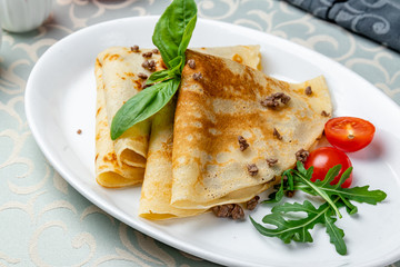 pancakes with meat on white plate