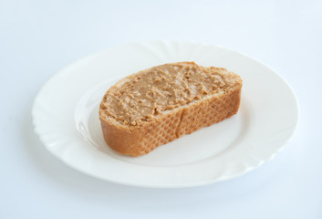 Fototapeta na wymiar peanut butter toast on a white plate isolated on white background