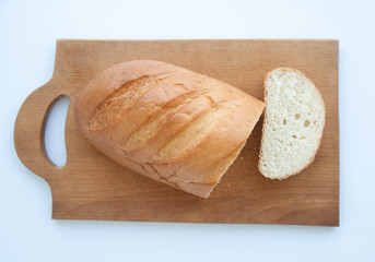 Sliced loaf of whole wheat bread on cutting board. Top view