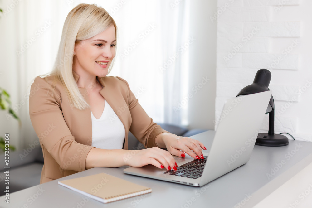 Wall mural Portrait of happy skilled middle aged woman life coach, business consultant, psychologist or medical advisor smiling joyfully at camera, working on laptop, enjoying her job, helping people online