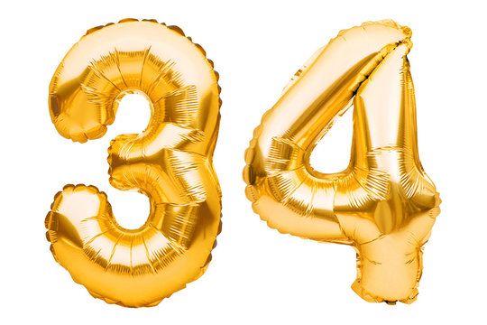 Number 34 thirty four made of golden inflatable balloons isolated on white. Helium balloons, gold foil numbers. Party decoration, anniversary sign for holidays, celebration, birthday, carnival