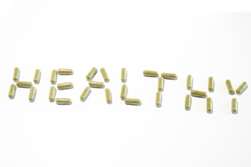 Healthy written with green pills