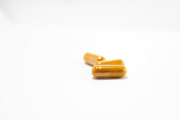 Three yellow pills (gel capsules with curcuma)
