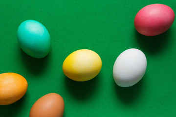 Colored easter eggs on green background