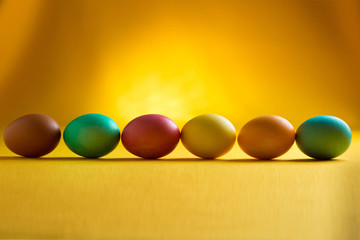 Colored easter eggs on a yellow background