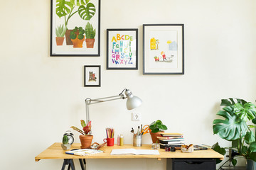 Artist's workplace for working from home with watercolor paints, brushes and sketchbooks. Place for design, illustration and creativity.