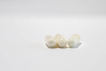 Three white pills (gel capsules with vitamine c)
