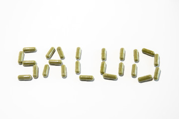 Health written with green pills (spanish)