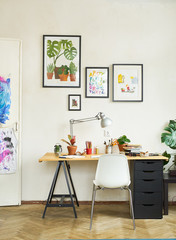 Artist's workplace for working from home with watercolor paints, brushes and sketchbooks. Place for design, illustration and creativity.