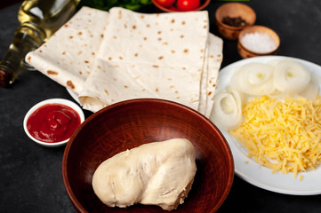 products for the preparation of burritos or shawarma on a stone background