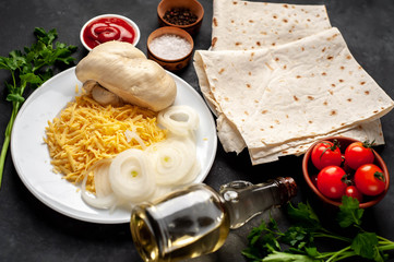 products for the preparation of burritos or shawarma on a stone background